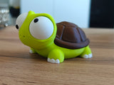 Detail of the turtle figure showing the rotating googly eyes and small smiling face