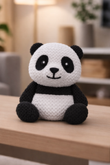 Black and white 3D-printed panda figure sitting upright, approximately 8 cm tall