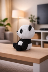 Panda figure positioned as desk decoration next to office supplies and plants