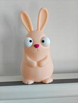 Goofy Easter bunny figure with large movable googly eyes on white background