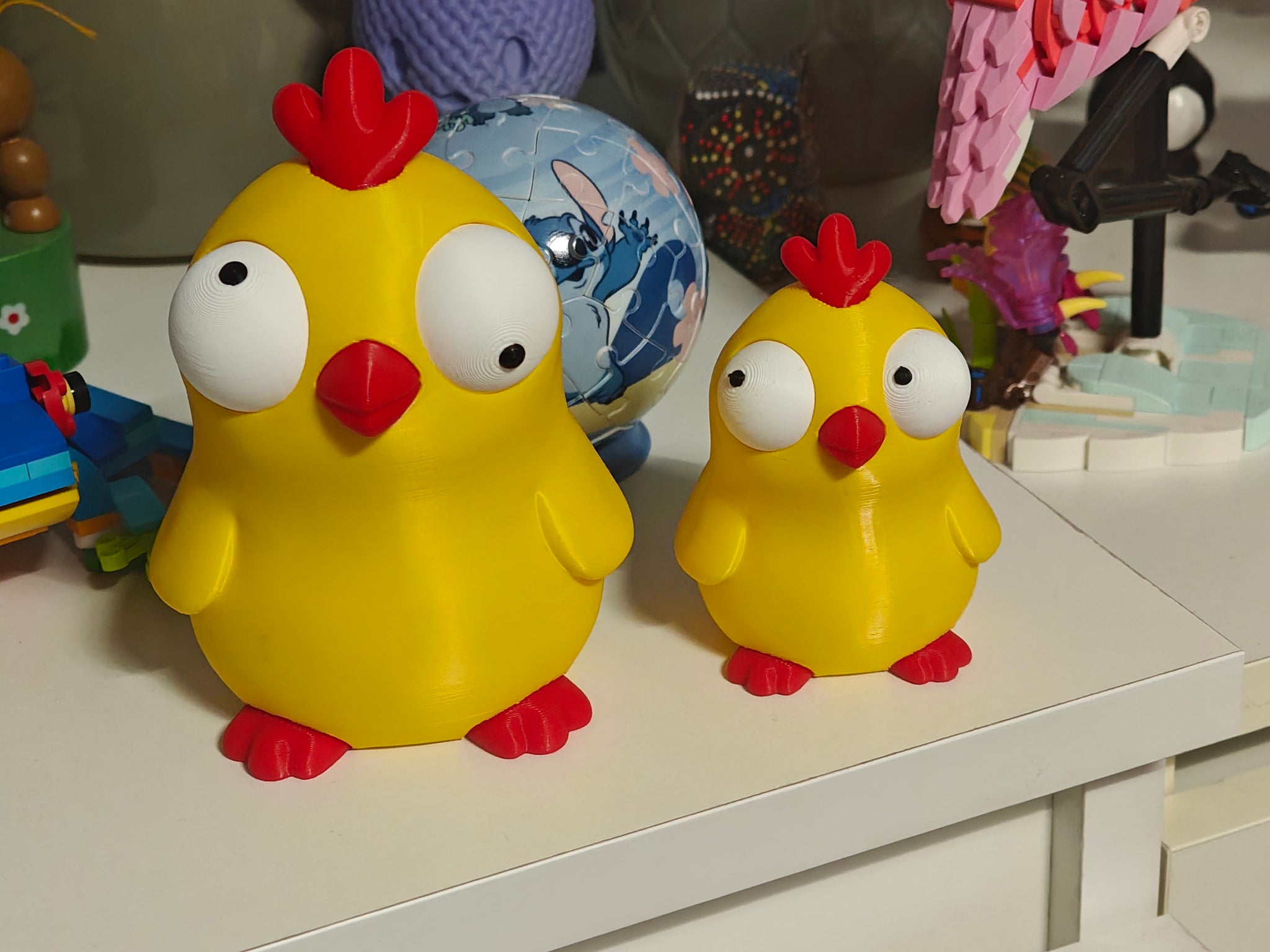 Close-up of goofy chicken figure with large movable googly eyes on white background