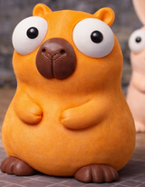 Capybara figure with big movable googly eyes, front view on white background