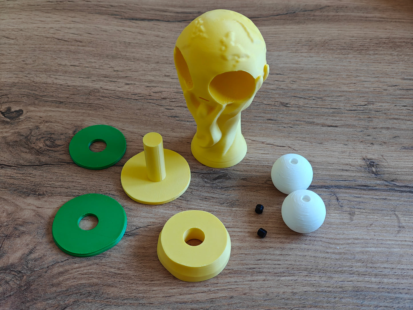 Goofy world cup trophy figure styled on a desk next to a keyboard and small decor items