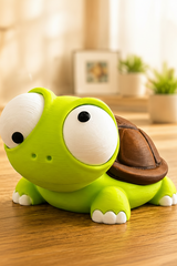 Close-up of cartoon turtle figure with oversized movable googly eyes on white background