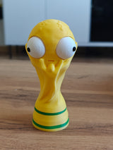Close-up of goofy world cup trophy figure with large movable googly eye, front view