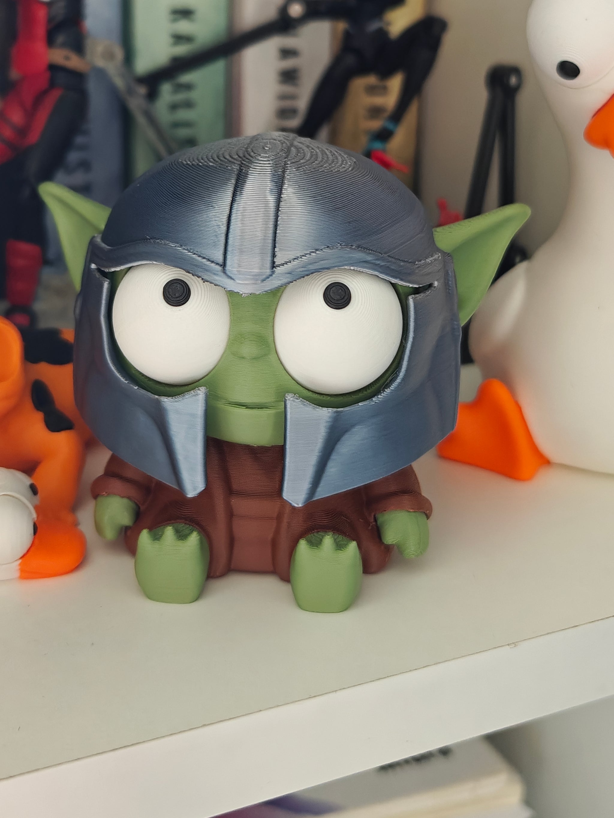 Goofy Yoda figure with movable googly eyes and oversized ears, front view on white background
