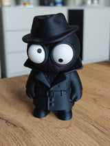 Spider Noir googly eyes figure with dark coat and hat, close-up on white background
