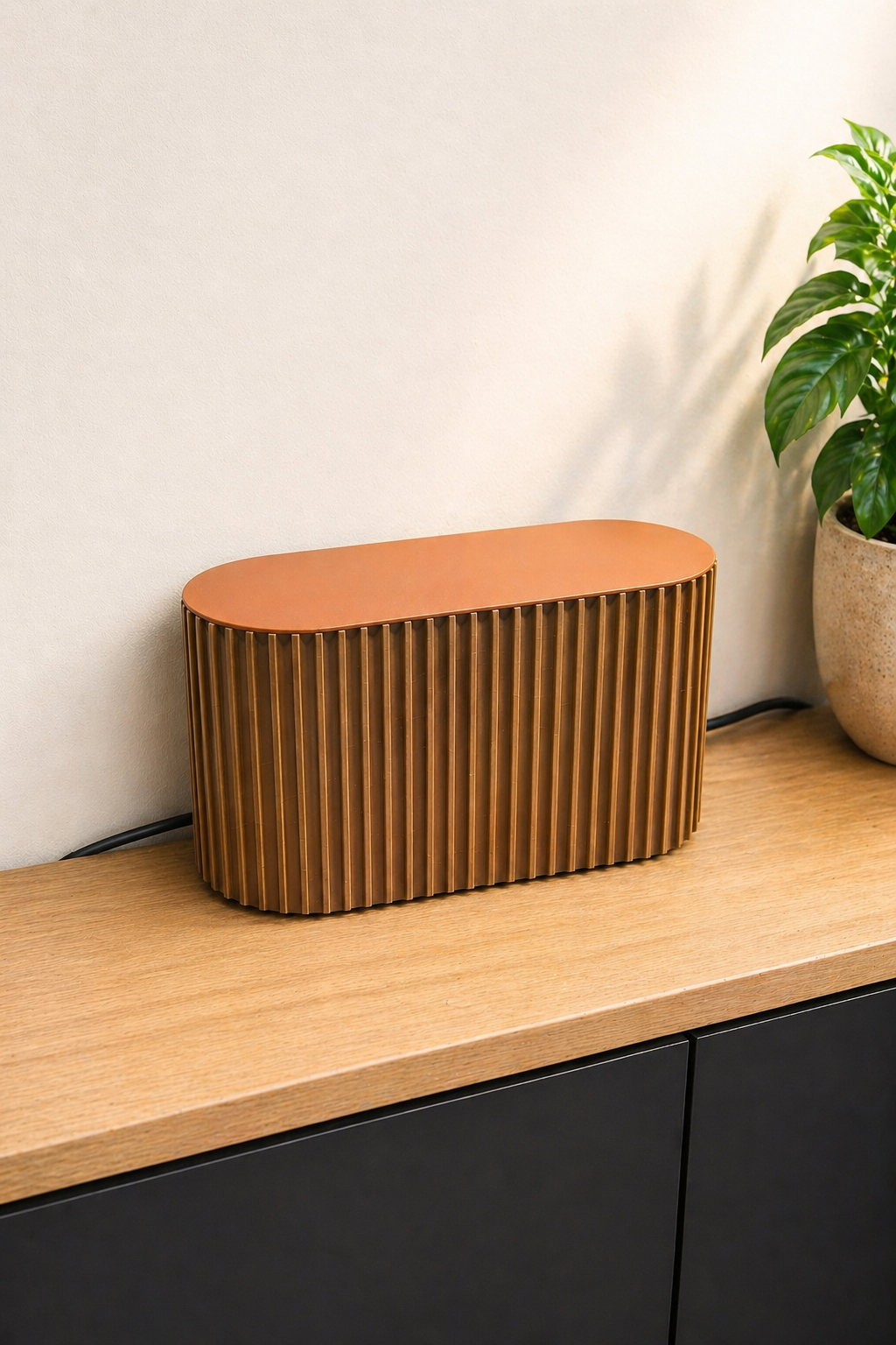 Beige cable management box with vertical ribbed design on white background
