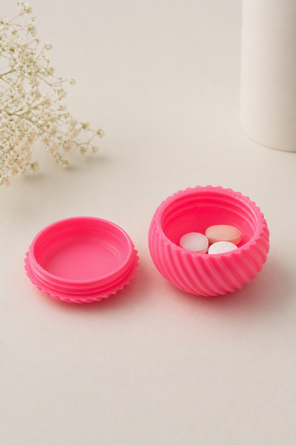 Cream-colored mini pillbox jar with ribbed design and screw lid, shown in actual size