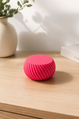 Close-up of threaded screw-on lid detail with textured grip surface on compact container