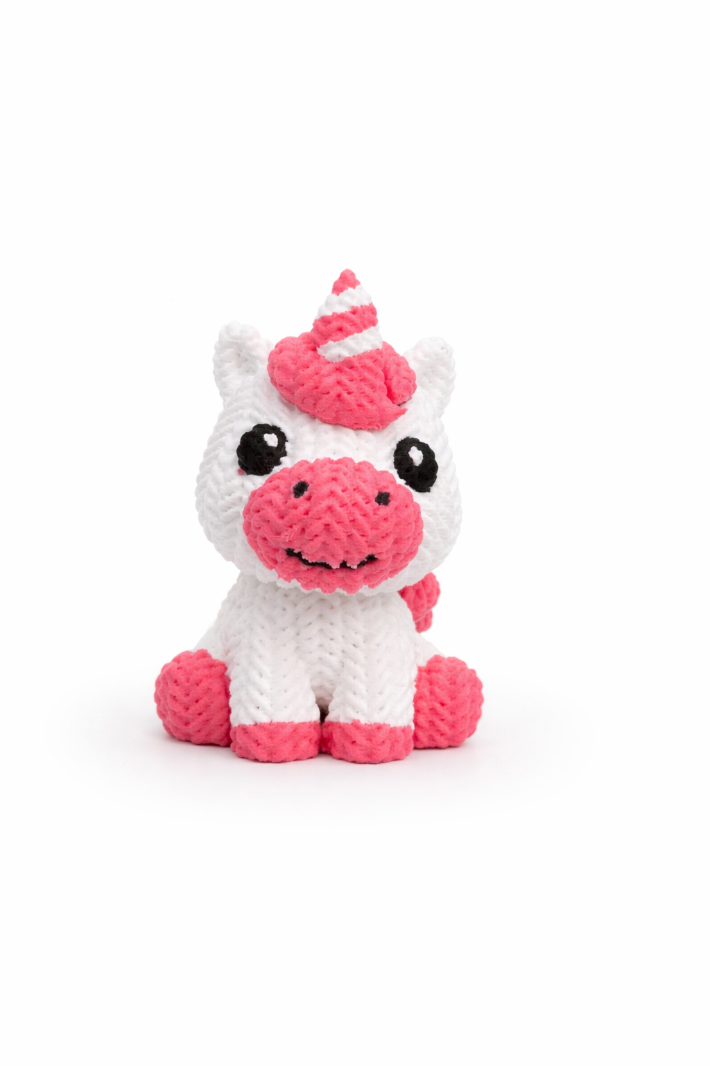 Unicorn figure displayed on wooden shelf next to books and decorative items