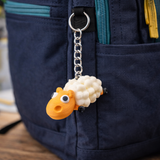 Compact sheep keychain charm displayed on bag or backpack