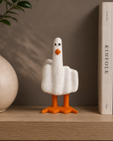 Decorative goose figurine on a shelf with books and a vase in the background