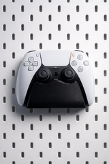 White PS5 DualSense controller holder mounted on IKEA Skadis pegboard with click-in connector