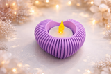 Cherry red heart holder glowing softly on bedside table with LED tealight lit