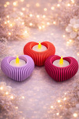 Heart-shaped purple tealight holder with ribbed design and included LED candle