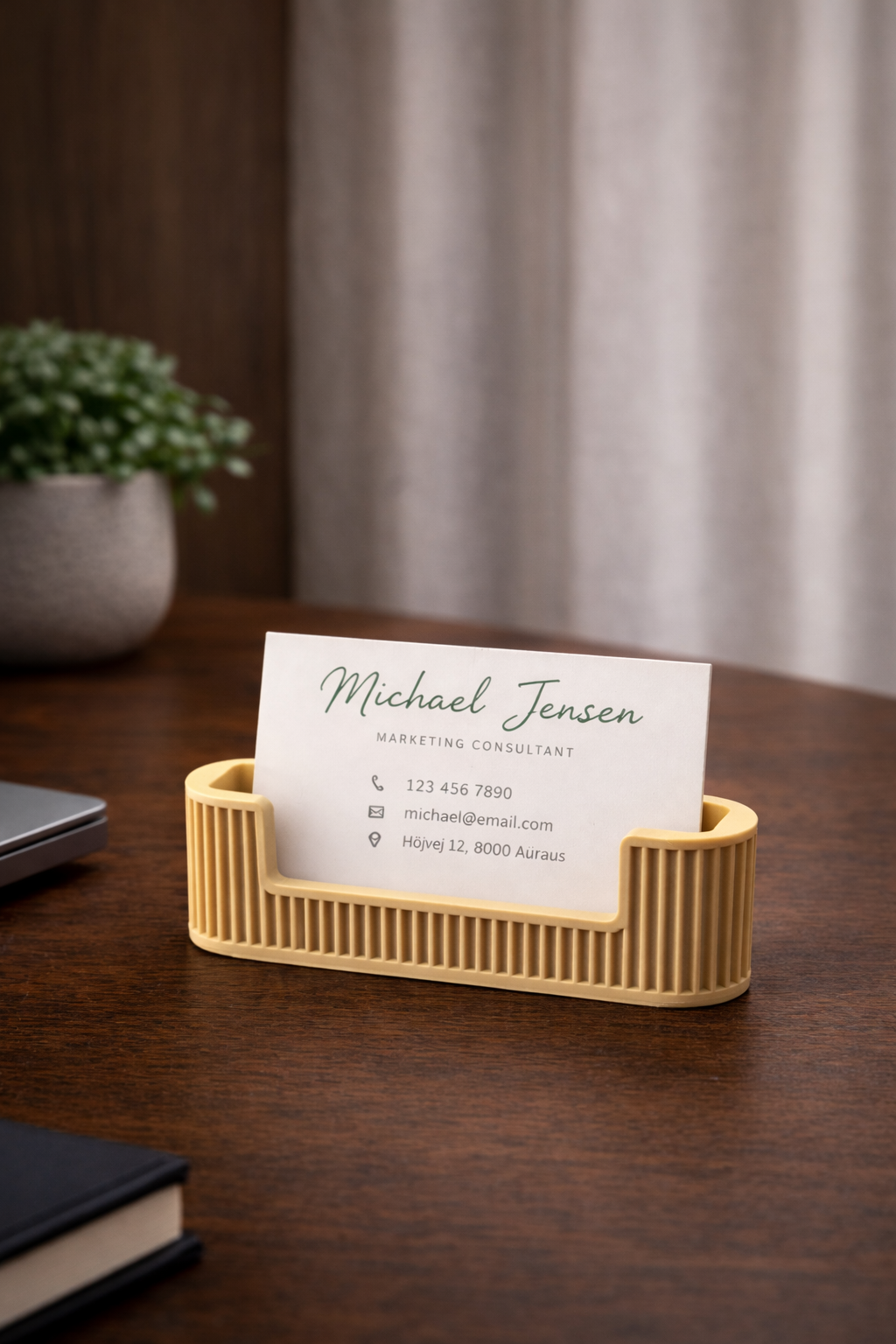 Beige business card holder with modern ribbed cylindrical design on white background