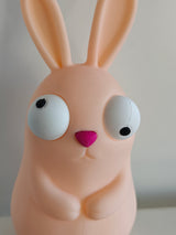 Goofy Easter bunny figure with large movable googly eyes on white background