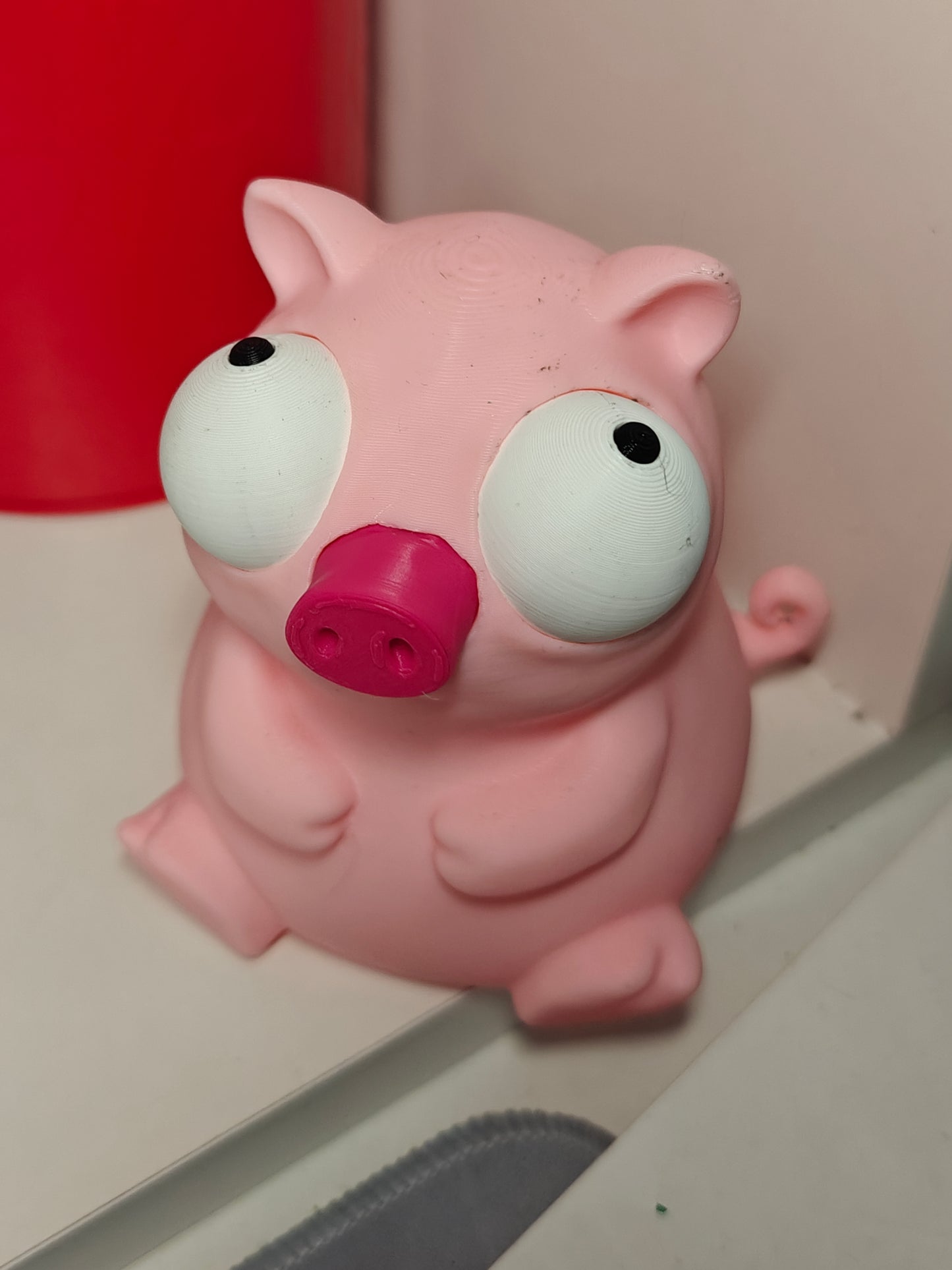 Close-up of Goofy Series pig figure with big movable googly eyes, front view