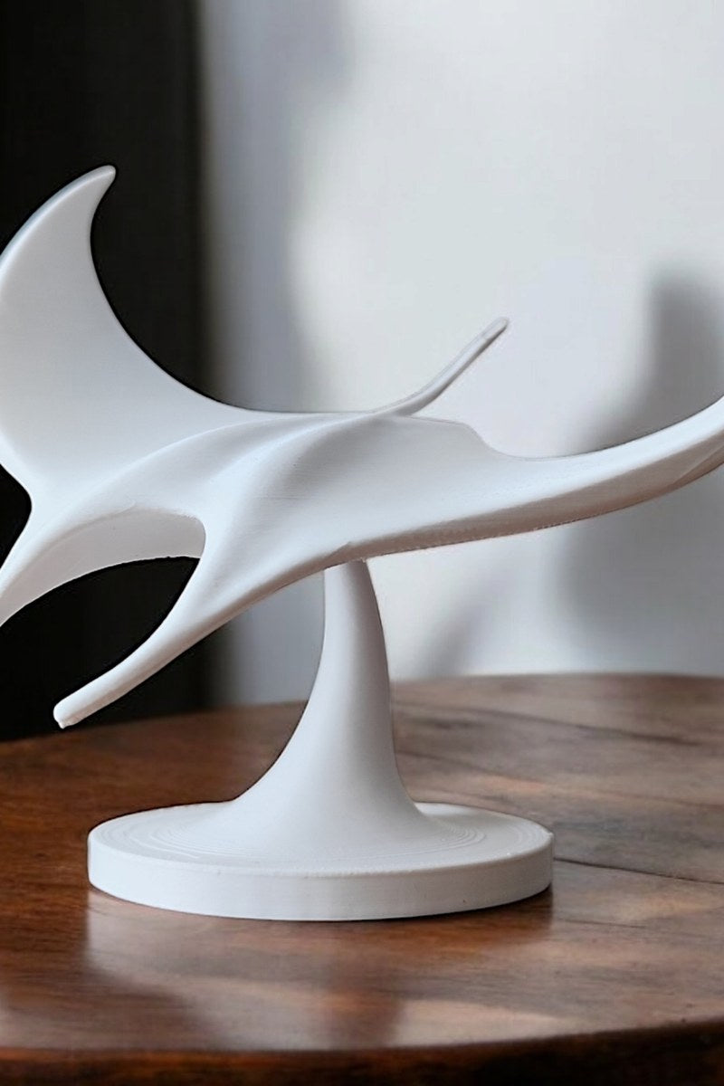 White manta ray sculpture viewed from above, wings spread in graceful formation