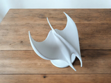Close-up of the manta ray sculpture's smooth white surface and swept-back wing details