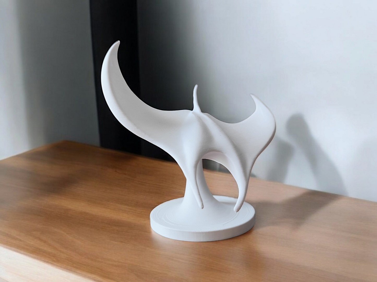White manta ray sculpture viewed from above, wings spread in graceful formation