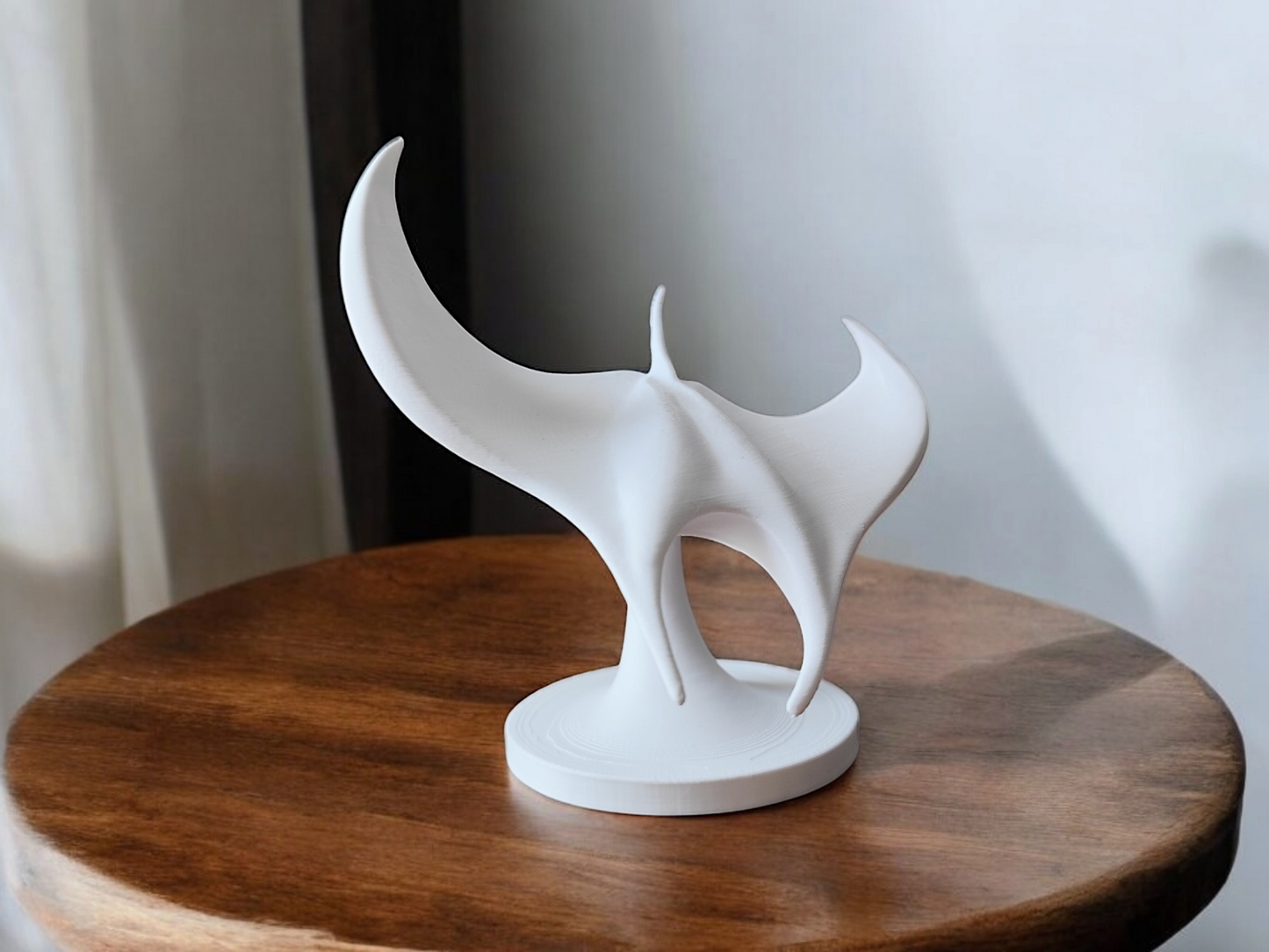 White manta ray sculpture viewed from above, wings spread in graceful formation