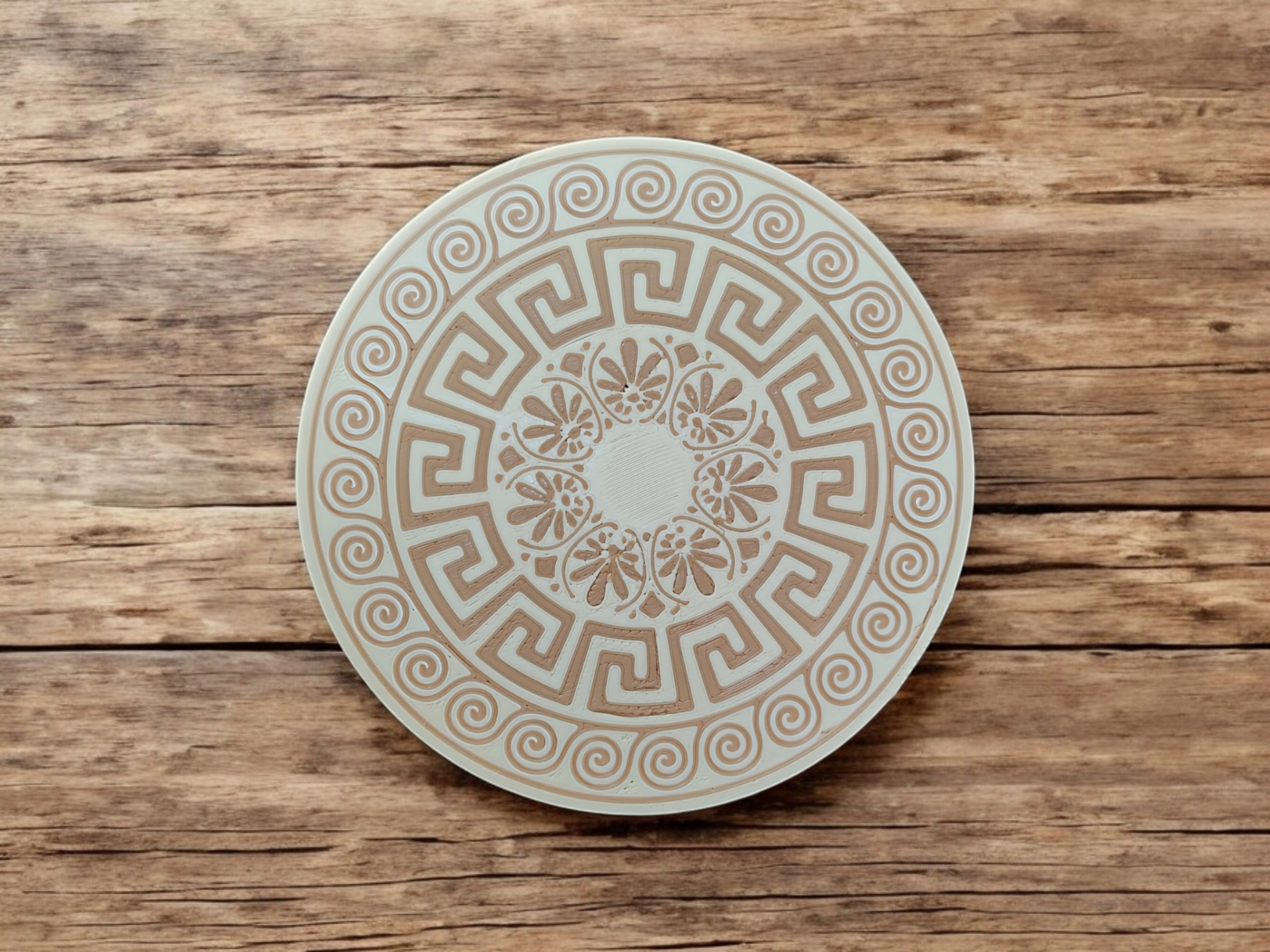 Detail of intricate Greek border pattern and color texture on coaster surface