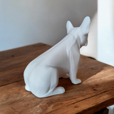 French bulldog sculpture displayed on a white shelf in a modern living room interior