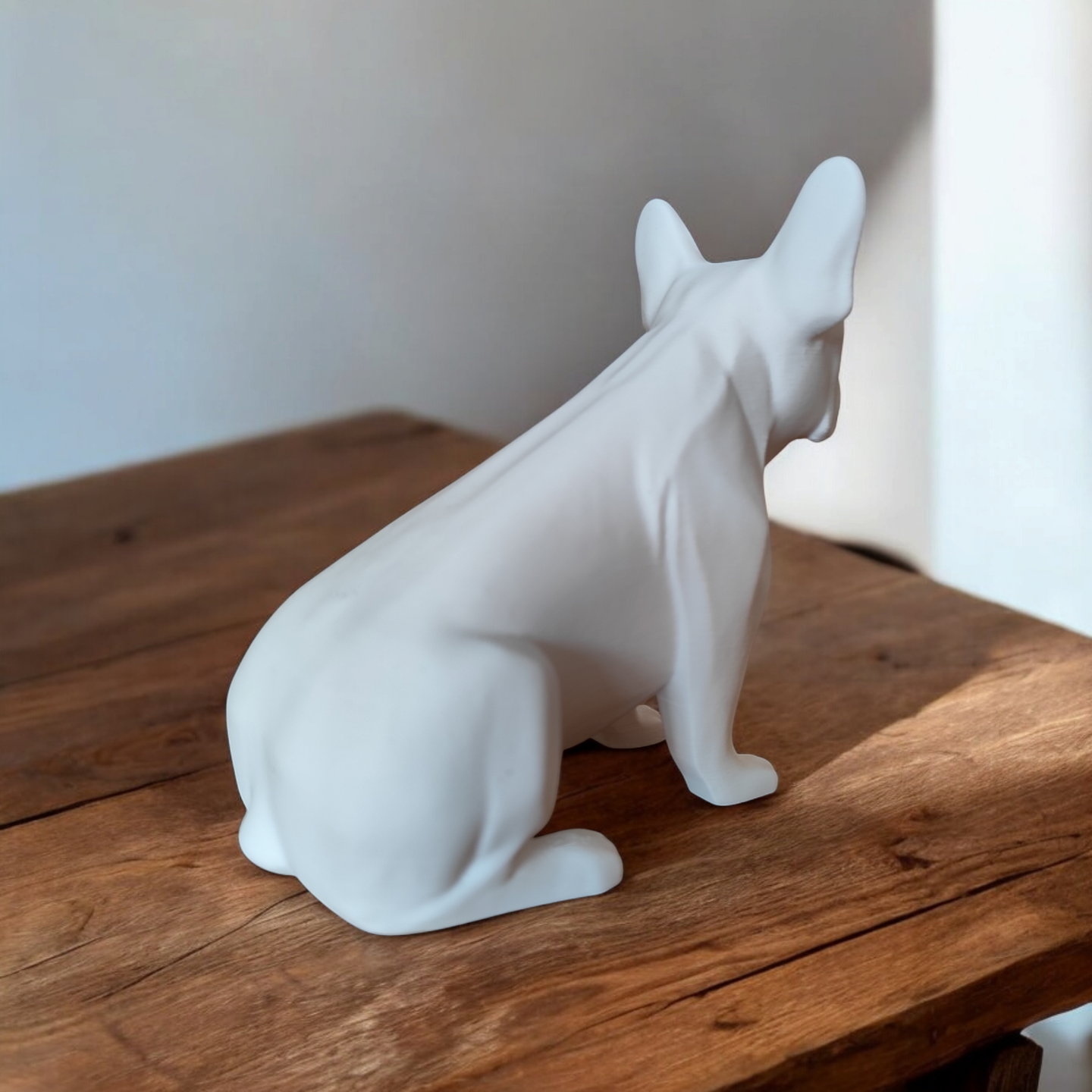 French bulldog sculpture displayed on a white shelf in a modern living room interior