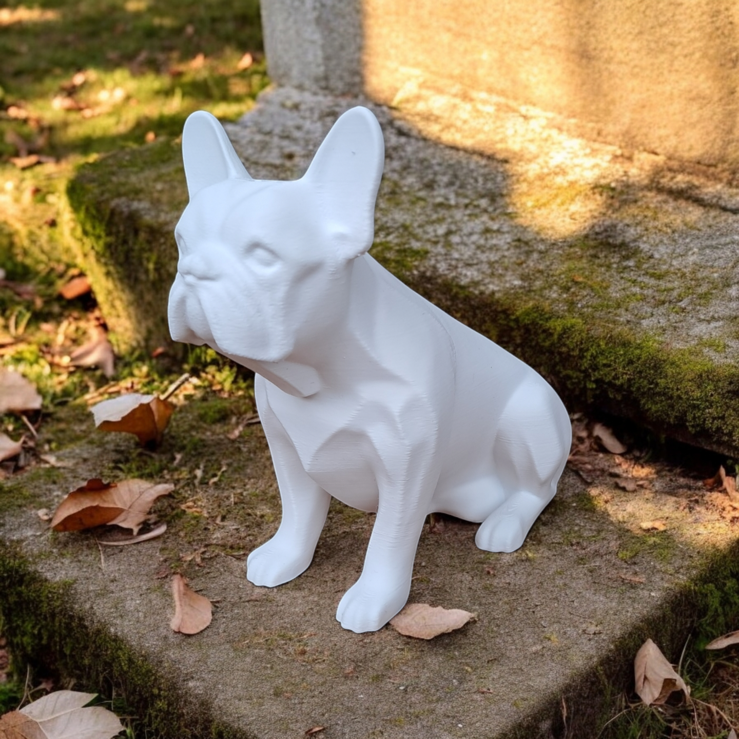 Close-up detail of the french bulldog sculpture's face and posture, smooth finish