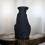 Close-up of minimalist pug sculpture showing smooth matte black surface