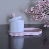 Close-up of ribbed jewelry organizer jar with lid and matching tray in pink and white