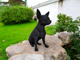 Chihuahua sculpture displayed on wooden shelf in Scandinavian interior