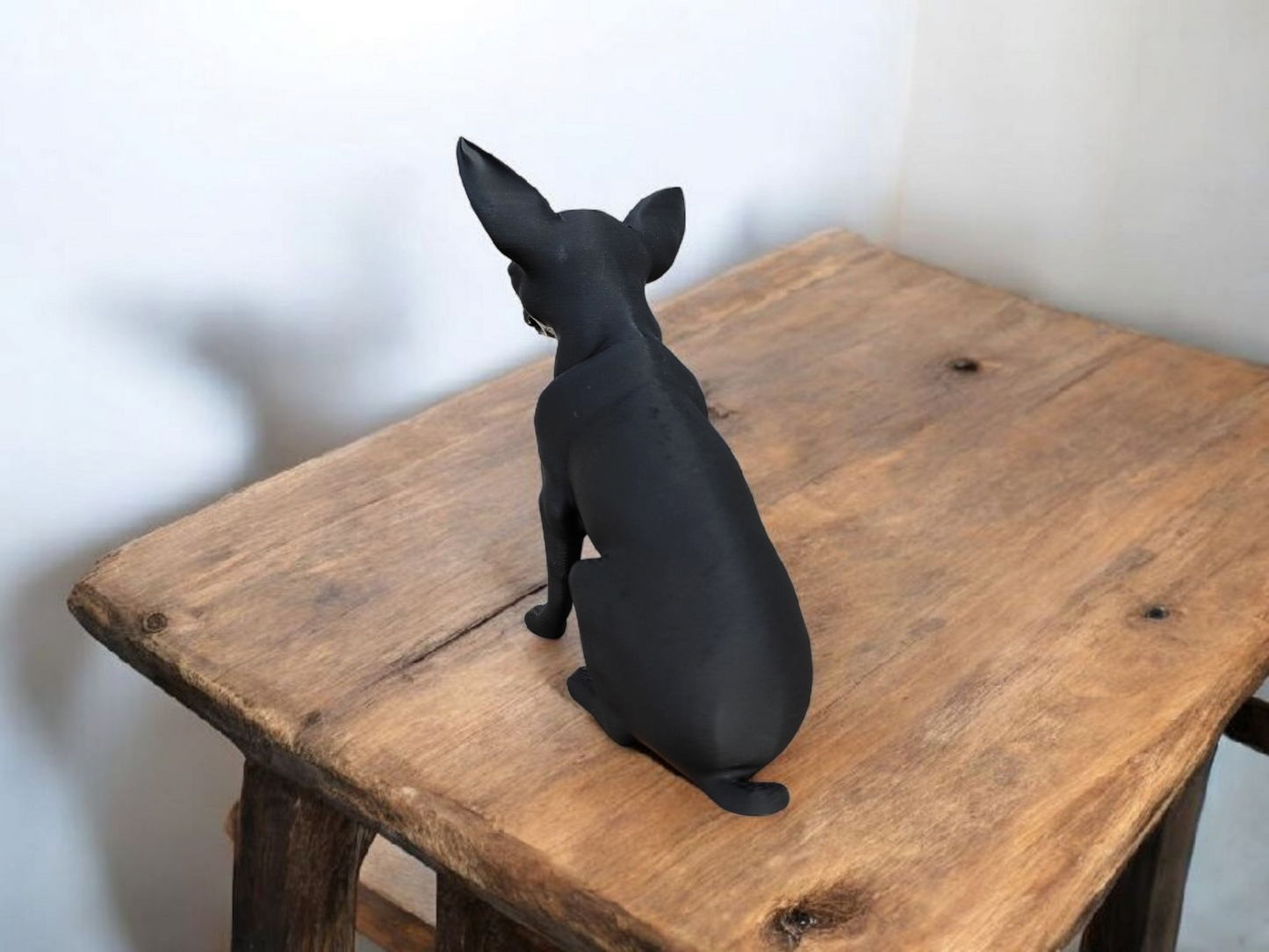 Close-up of minimalist chihuahua sculpture showing clean profile and alert posture