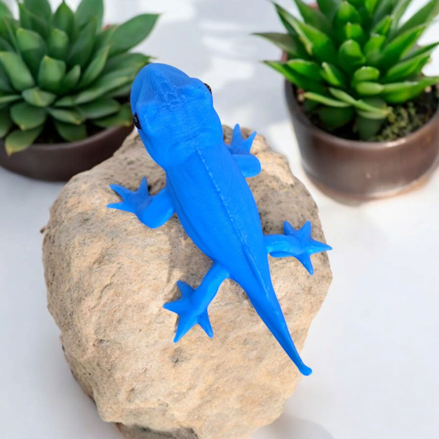 Gecko figurine detail showing textured surface and charming profile