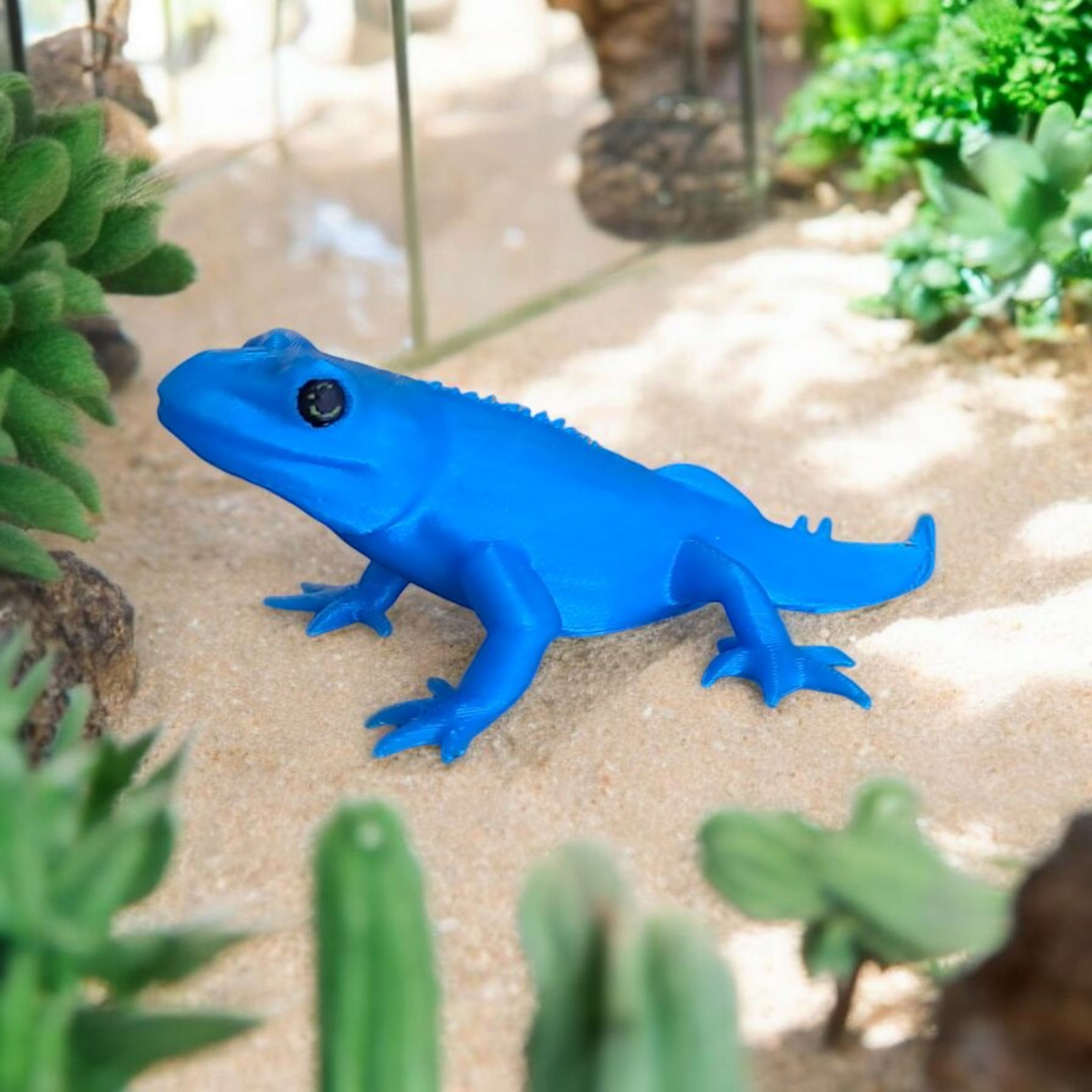Close-up of a cute gecko figurine with detailed features and playful proportions