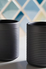 Close-up of ribbed toothbrush holder showing horizontal texture and clean cylindrical form
