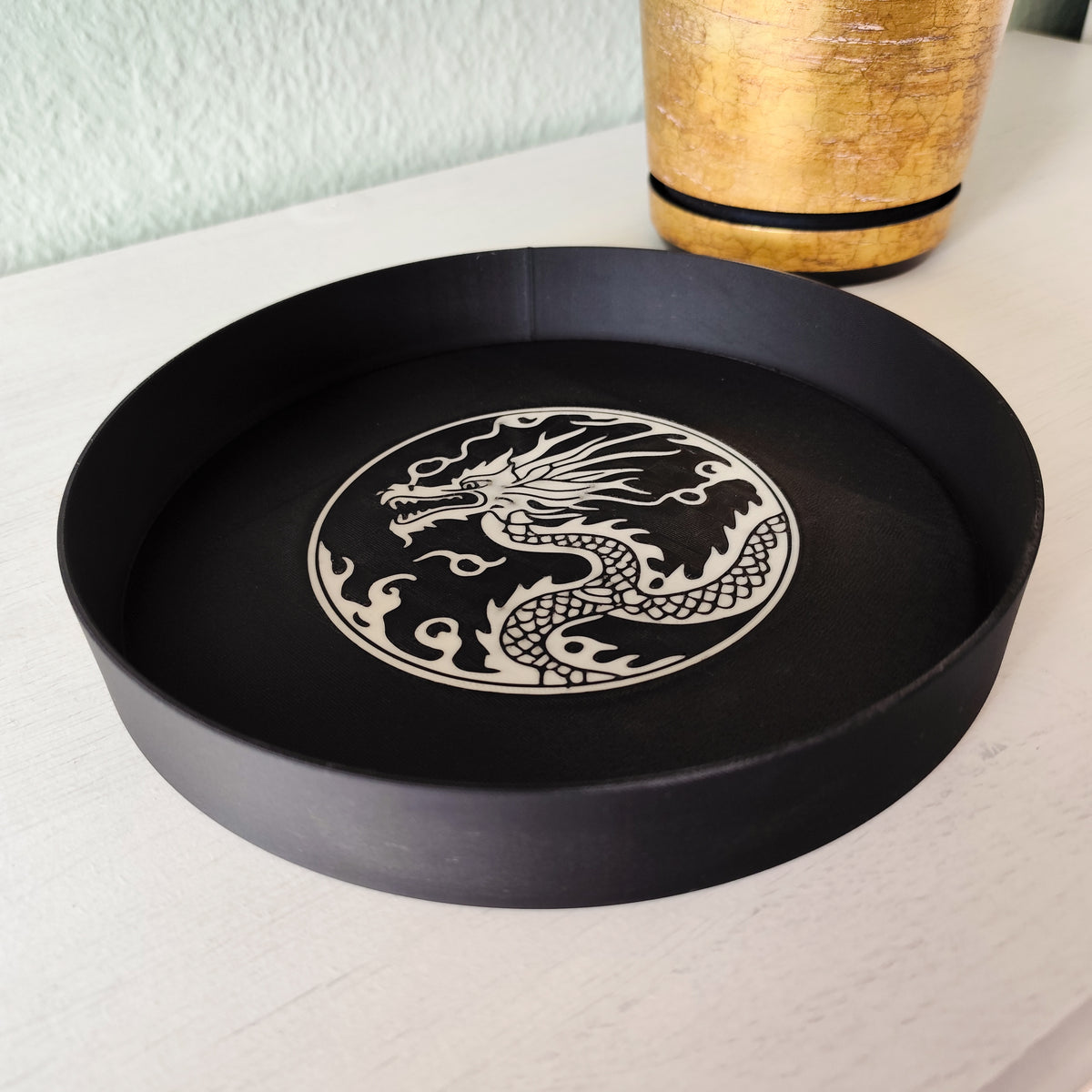 Dragon relief tray styled on desk holding keys and small items