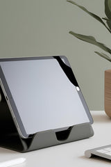 Minimalist iPad stand in white, showing angled design and stable base