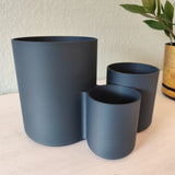 Kitchen utensil holder styled on countertop next to stove with wooden spoons