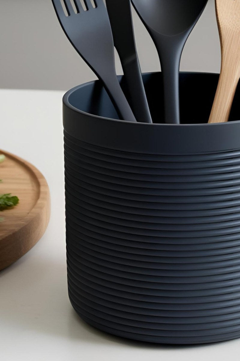 Close-up of ribbed utensil holder with wooden spoon inside, showing vertical texture detail