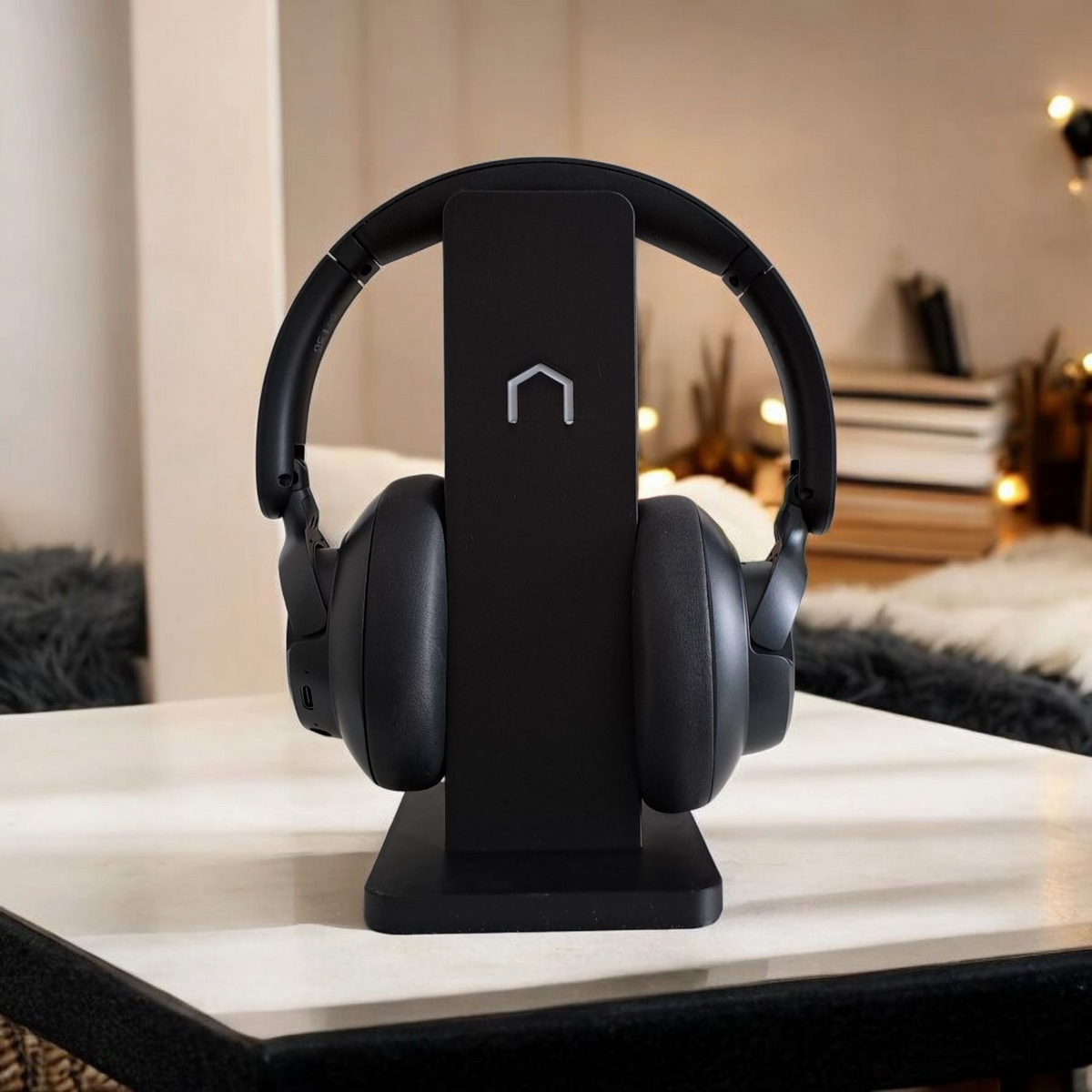 Clean headphone holder styled on a minimal desk with computer setup and ambient light