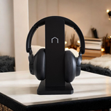 Clean headphone holder styled on a minimal desk with computer setup and ambient light