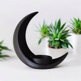 Crescent moon plant pot styled on wooden shelf with small succulent, minimalist room setting
