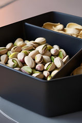 Minimalist pistachio bowl with two compartments, close-up of matte surface and clean geometry