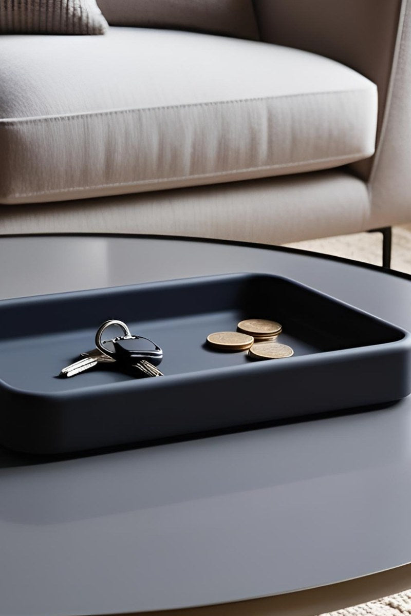 Minimalist rectangular catchall tray in light grey, close-up view showing clean edges