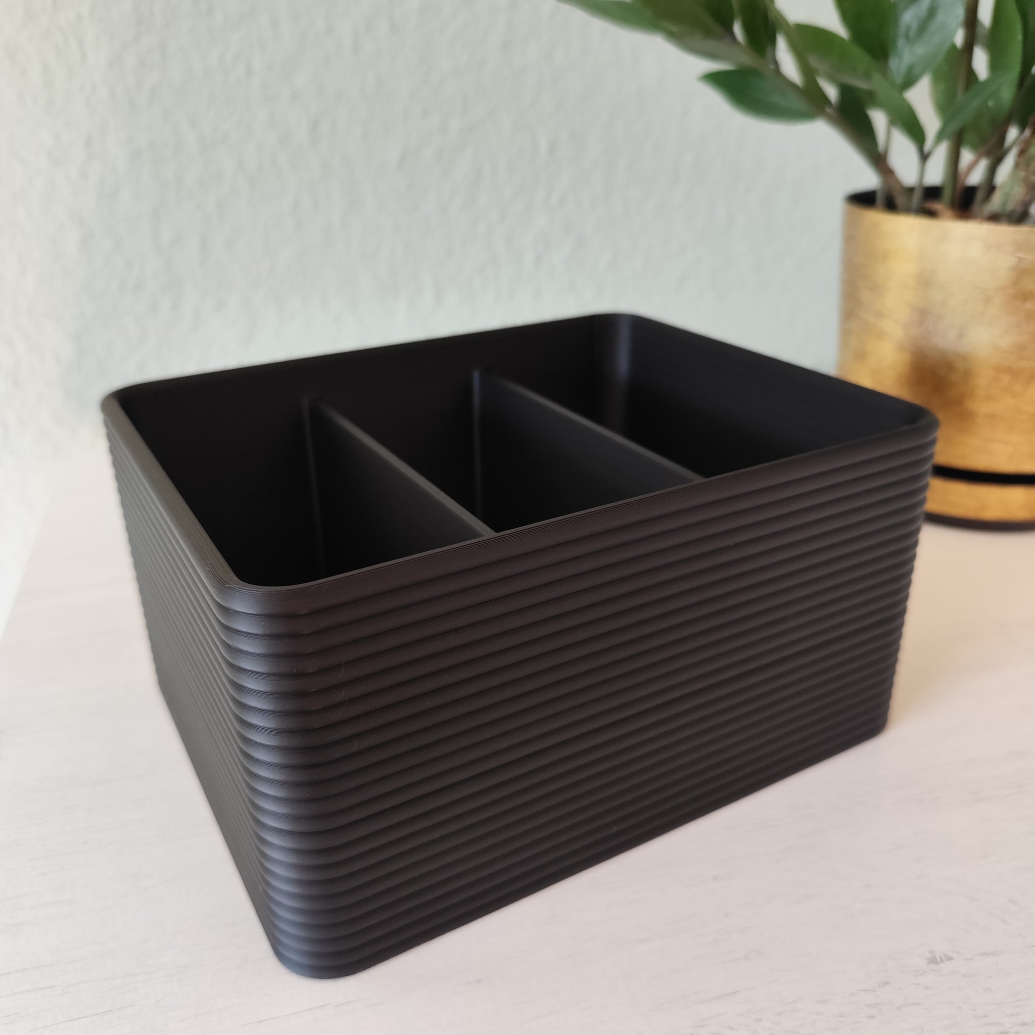 Ribbed remote control holder on wooden coffee table with remotes inside