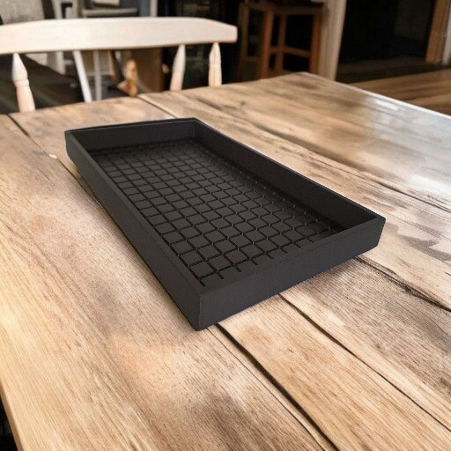 Minimalist key tray displayed on a wooden desk with keys and coins