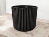 Textured surface of ribbed cup catching soft light